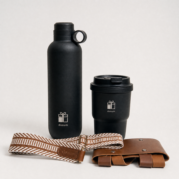Donum UAE lifestyle gift hamper — featuring premium stainless steel water bottle and travel coffee mug alongside curated gourmet treats and lifestyle essentials, presented in a handwoven wicker hamper.